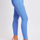 Woman wearing blue Hyperstretch Mid-Rise Skinny Pants by YMI Jeans, showcasing the sleek and stylish fit perfect for any occasion.