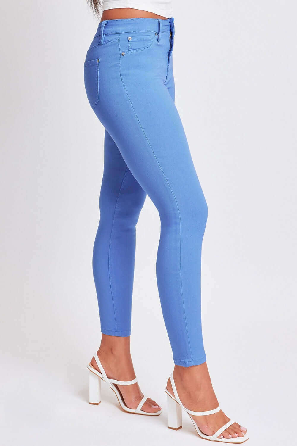 Woman wearing blue Hyperstretch Mid-Rise Skinny Pants by YMI Jeans, showcasing the sleek and stylish fit perfect for any occasion.