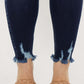 Close-up of Cat's Whiskers Raw Hem High Waist Jeans with frayed detailing at the ankles, paired with woven sandals.