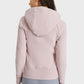 Back view of female in Millennia Zip Up Hooded Sports Jacket, showcasing stylish seam detailing and cozy hood.