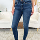 Woman wearing Classic Handsand Skinny Jeans by Judy Blue Jeans standing in a stylish living room.