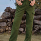 Model wearing Bella Road High Waist Cargo Straight Jeans in green standing outdoors.