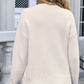 Back view of a woman wearing an Angel Wings Bow Graphic Round Neck Long Sleeve Sweater in a light color, paired with denim jeans.