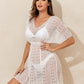 Woman wearing a sheer white V-Neck Half Sleeve Cover-Up made of 100% polyester, perfect for beachwear. Machine washable and stretchy fabric.