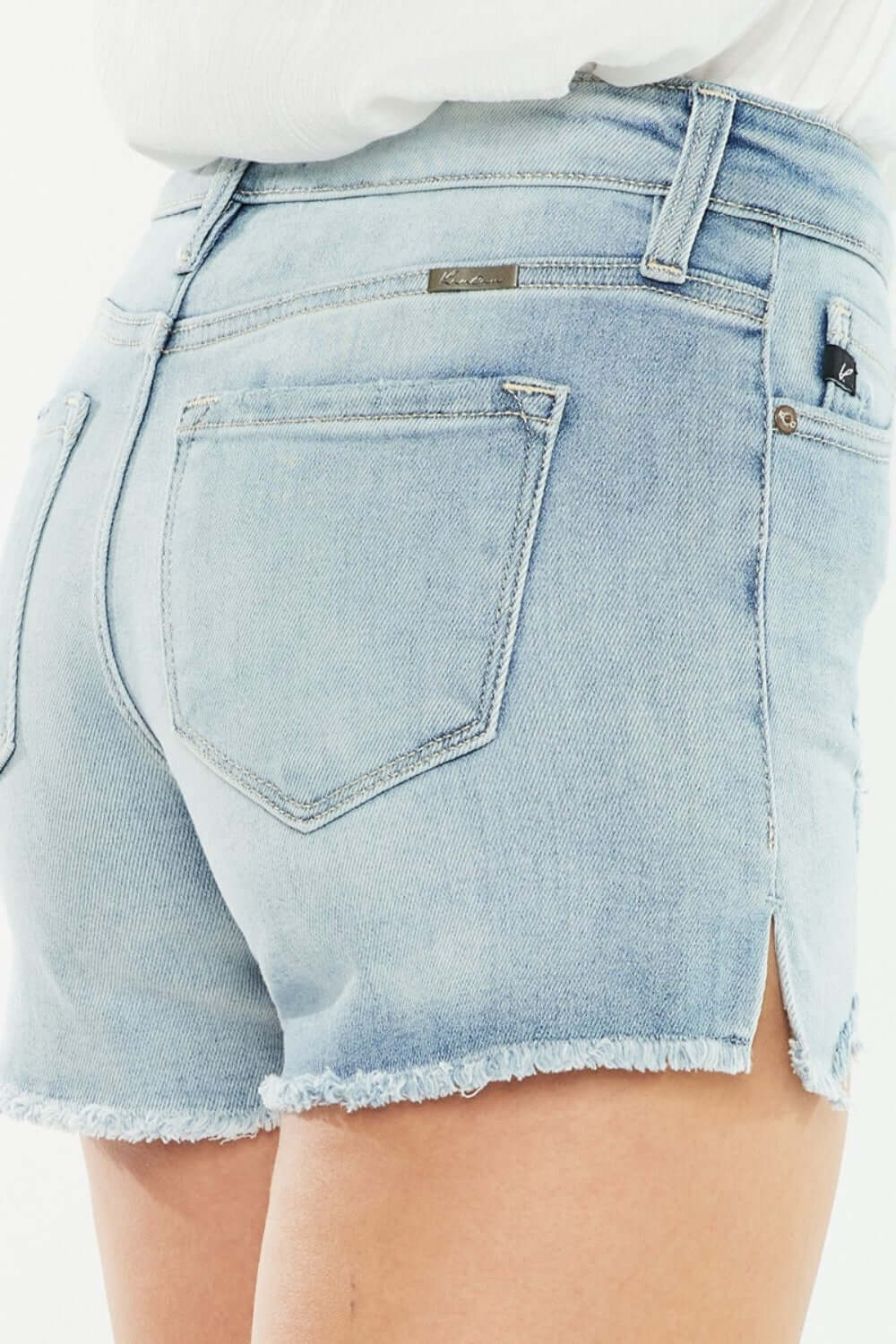 High Rise Side Slit Denim Shorts, back view showing side slit detailing and high-rise waist in light wash denim.