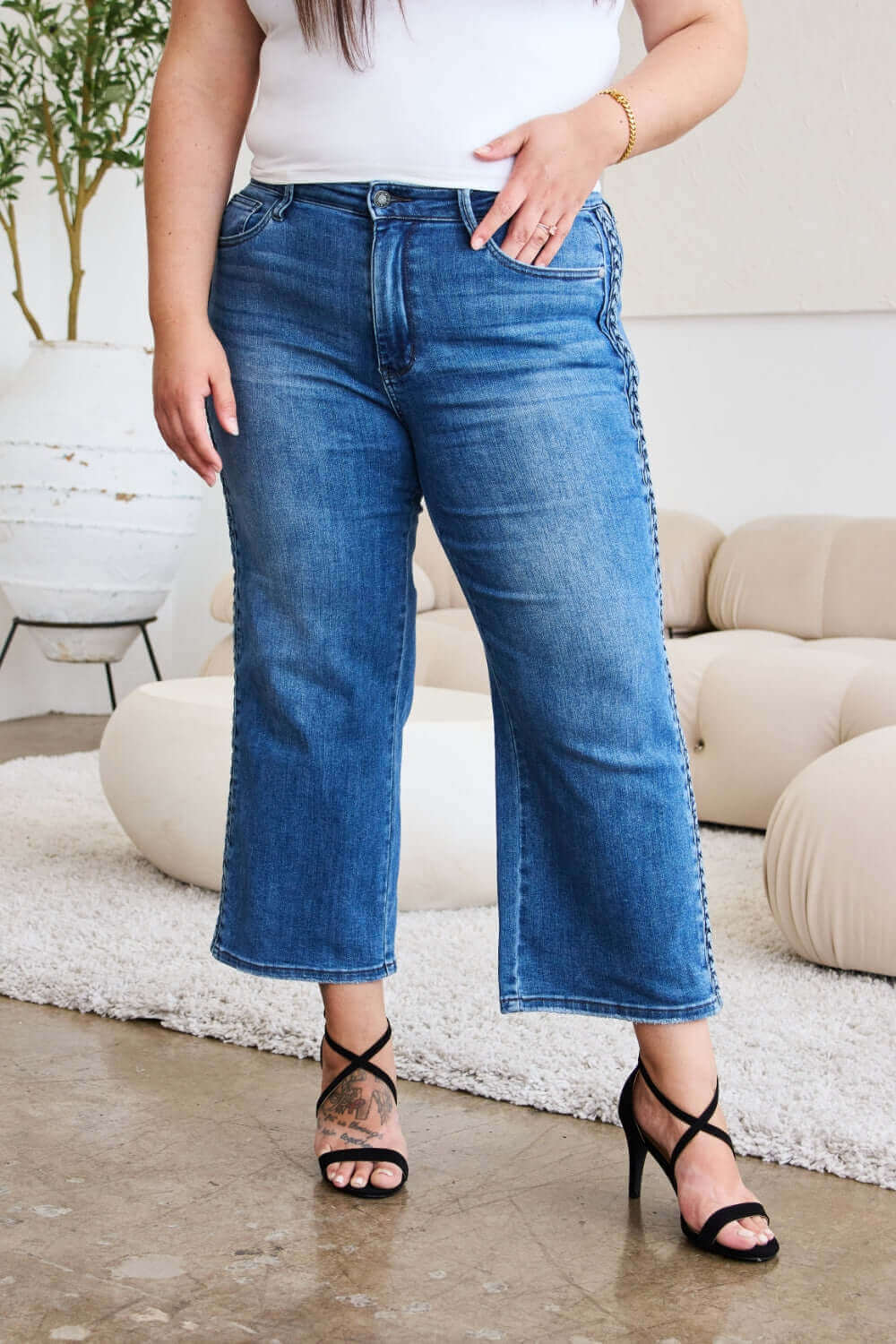 Woman wearing Judy Blue Jeans braid side detail wide leg design with heels