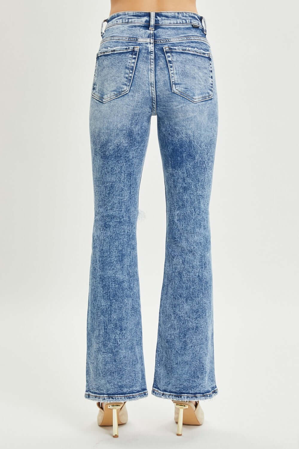 High Rise Distressed Flare Jeans by Risen Jeans in Light Wash, back view showcasing vintage-inspired style and retro 70s vibe