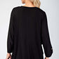 Back view of a stylish black blouse with three-quarter sleeves and button detail, perfect for any occasion.