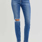 High rise ankle skinny jeans with knee distressing, featuring a flattering fit and slightly stretchy material, perfect for casual or dressy wear