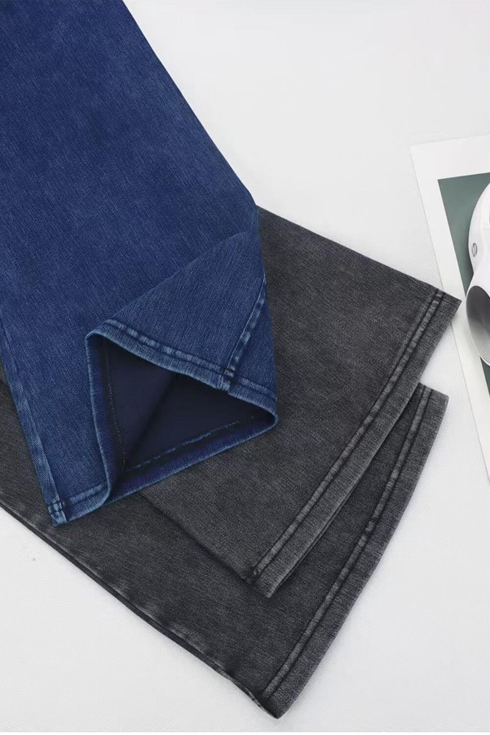 Two pairs of Basic Bae bootcut jeans in dark denim and gray, showcasing their stylish cut and versatility.