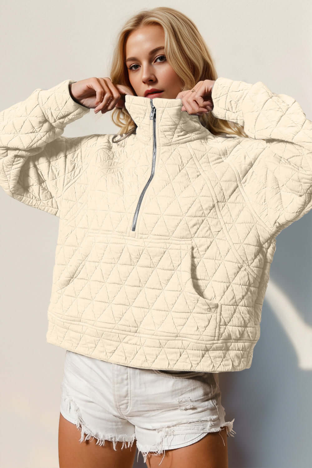 Woman wearing cream Half Zip Long Sleeve Quilted Sweatshirt with Pocket, showcasing cozy and stylish design.