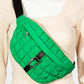 Stylish green quilted sling bag with bubble texture and carabiner buckle, perfect for carrying essentials on the go.