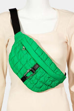 Stylish green quilted sling bag with bubble texture and carabiner buckle, perfect for carrying essentials on the go.