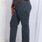 Woman modeling Cassidy Full Size High Waisted Tummy Control Striped Straight Judy Blue Jeans with superior tummy control design.