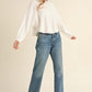 Woman wearing Bella Road Mable Round Neck Dolman Sleeve Cropped Sweater with jeans and a cap, posing in casual outfit