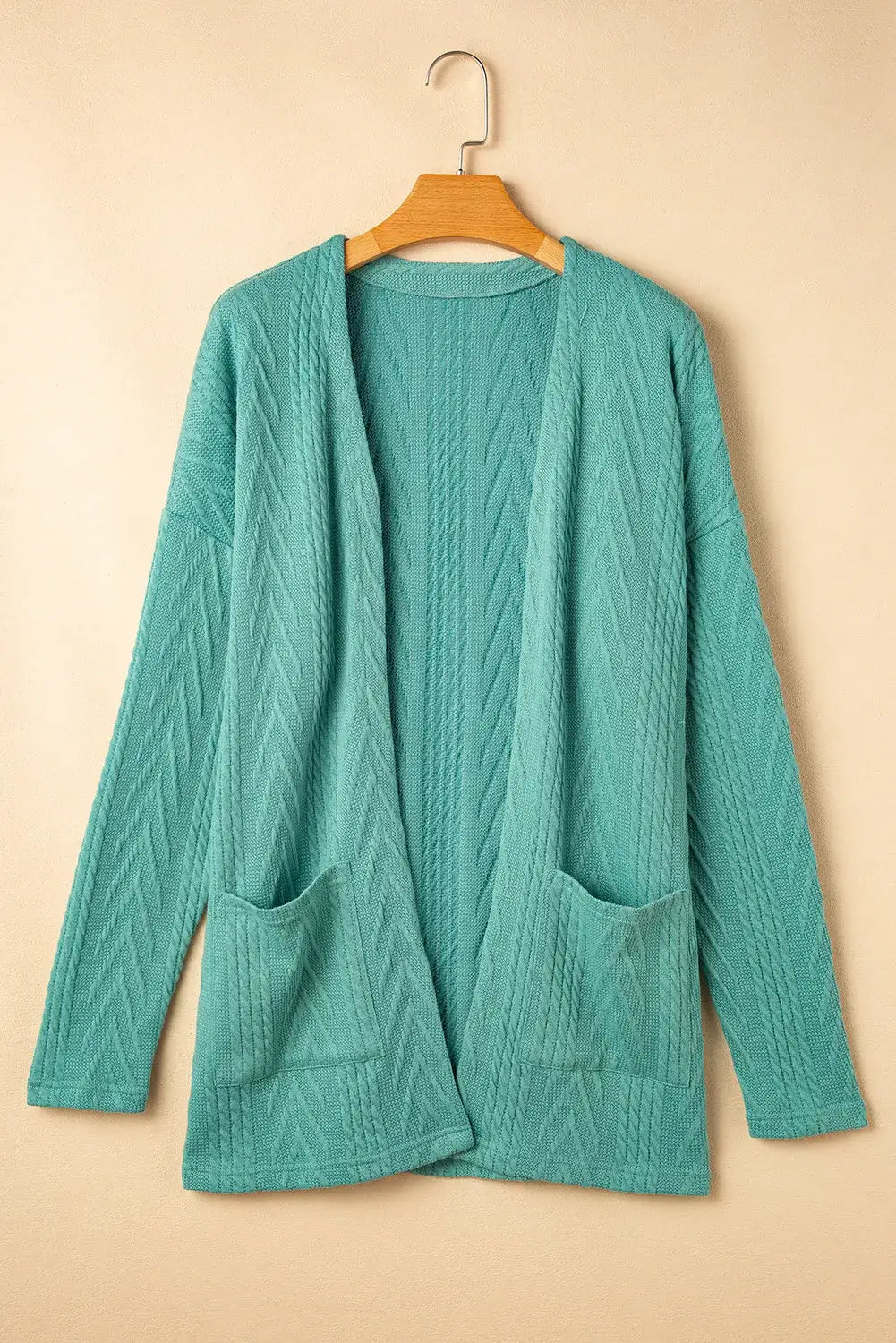 Teal textured open front cover up with pockets made of 97% polyester and 3% elastane, slightly stretchy and machine washable.