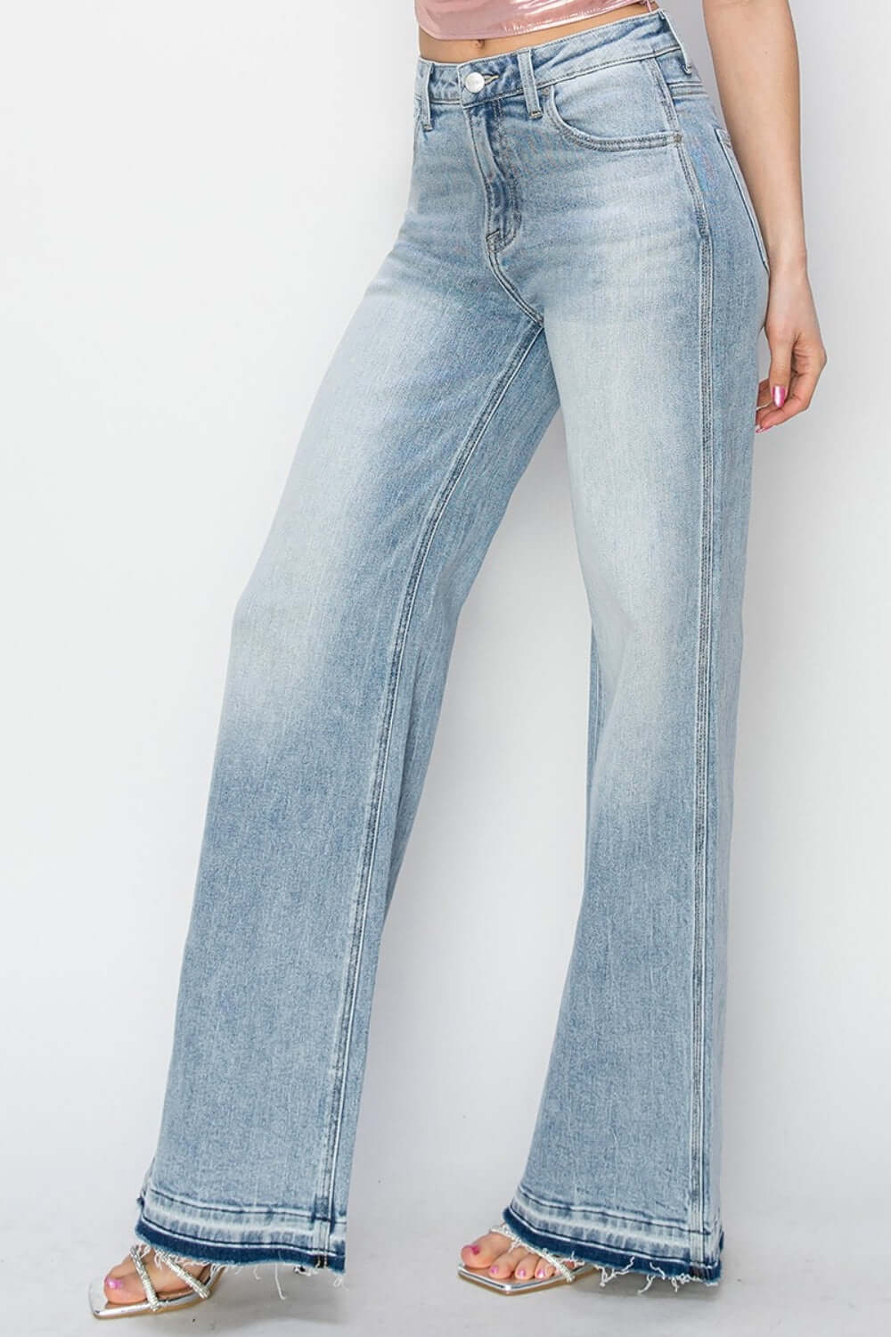 High rise wide leg jeans in light blue denim by Risen Jeans for a stylish and flattering look with a retro flair.