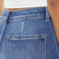 Close-up of ultra high waist gradient flare jeans in blue denim, showcasing back pocket and stitching details.