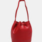 Red Nicole Lee USA Amy Studded Bucket Bag with drawstring closure crafted from high-quality pebbled vegan leather, front view.