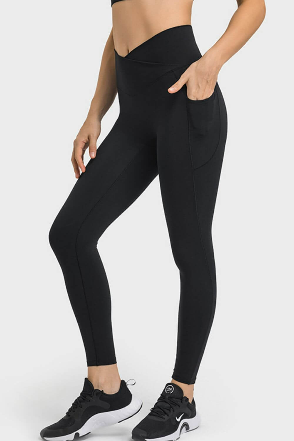 Black Millennia V-Waist Yoga Leggings with pockets, perfect for yoga and workouts, showcasing a flattering fit and breathable material.