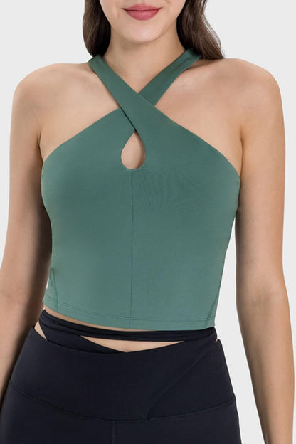 Stylish green active cami with crisscross design and unique neckline, perfect for workouts and gym sessions.