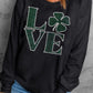 Black sweatshirt featuring rhinestone "LOVE" design with clover, perfect for style and comfort. Ideal for playful wardrobes.