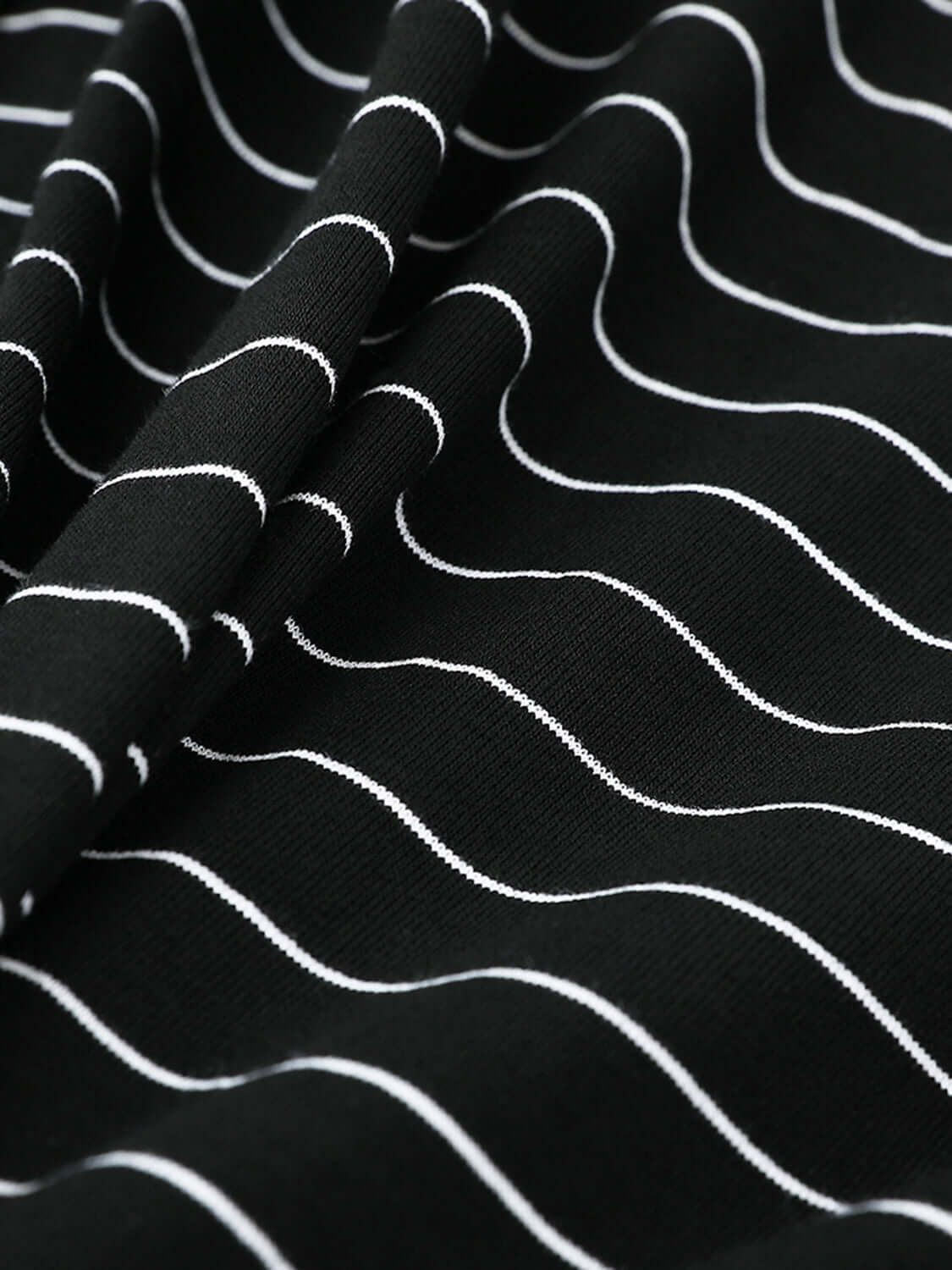 Close-up of Bella Road Round Neck Long Sleeve T-Shirt with black and white wavy stripe pattern on slightly stretchy fabric.