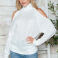 Woman wearing Bella Road Cable-Knit Turtleneck Cold Shoulder Sweater in white, perfect for cozy and stylish chilly days.