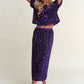 Woman wearing a purple sequin back slit midi skirt set, striking a pose in stylish sandals.