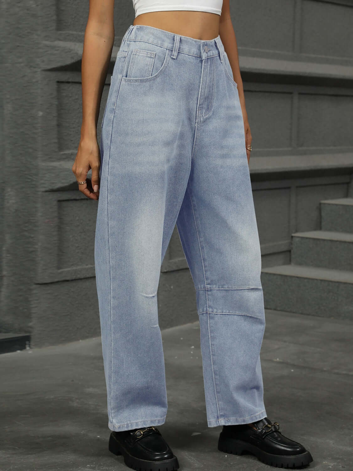 Woman wearing half elastic waist straight leg jeans, showcasing a comfortable and stylish fit. Denim features slight stretch for flexibility.