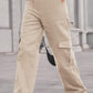 Woman wearing Baeful Long Straight Leg Jeans with Pockets in beige, displaying casual chic style.