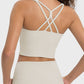 Back view of the Millennia Crisscross Round Neck Active Tank showcasing stylish sheerness and crisscross straps.