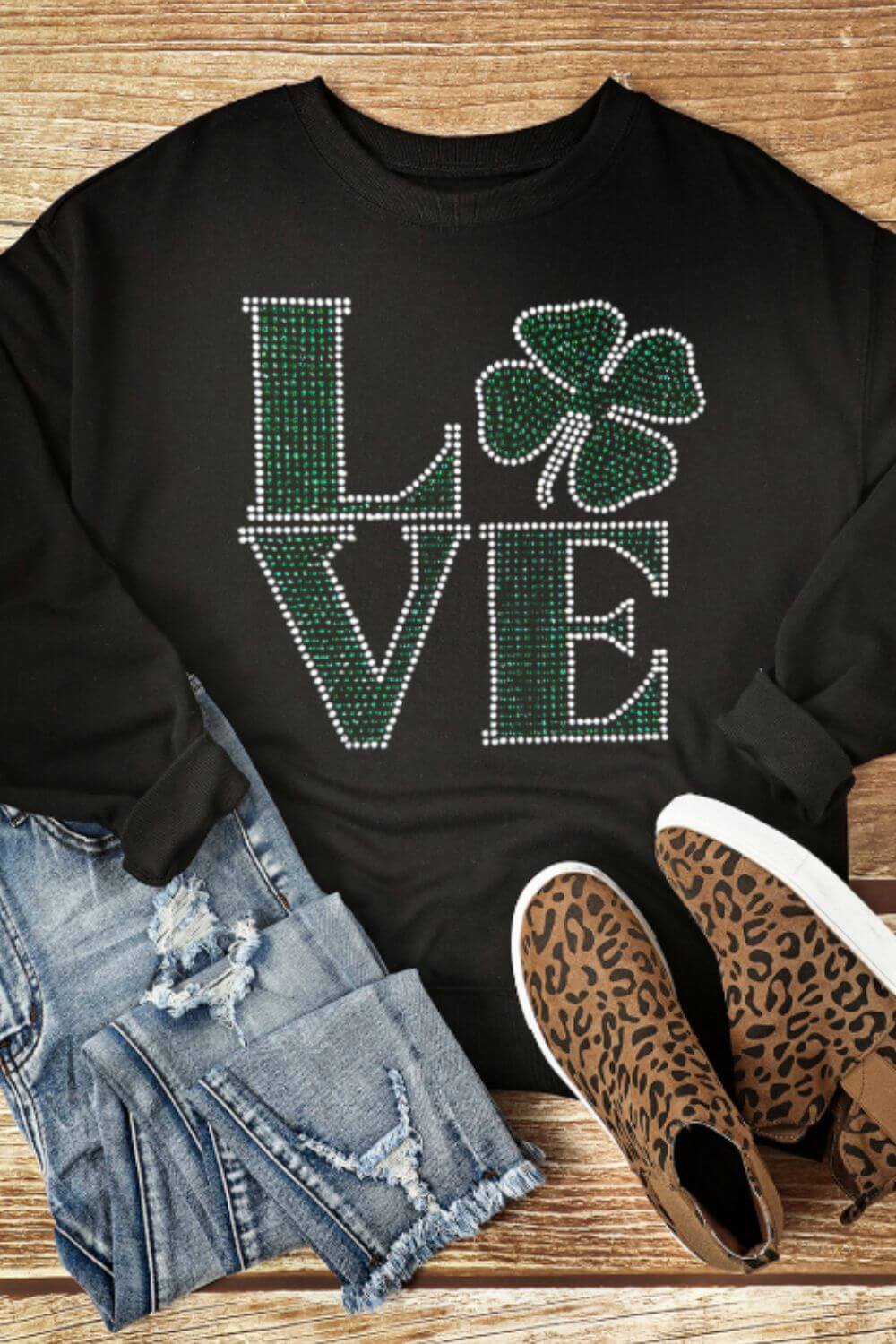 Bella Road LOVE Rhinestone Clover sweatshirt styled with distressed jeans and trendy leopard print sneakers.