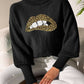 Woman wearing Bella Road Lip Turtleneck Long Sleeve Sweater in black with leopard print lips design.