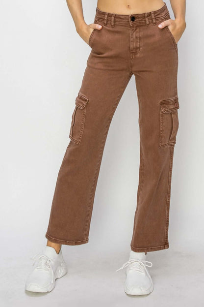 Brown high-rise cargo jeans with military-inspired pockets and a flattering fit, paired with white sneakers.