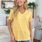 Woman wearing Bamboo V-Neck High-Low T-Shirt in yellow with slightly stretchy fabric made of 95% bamboo and 5% spandex.