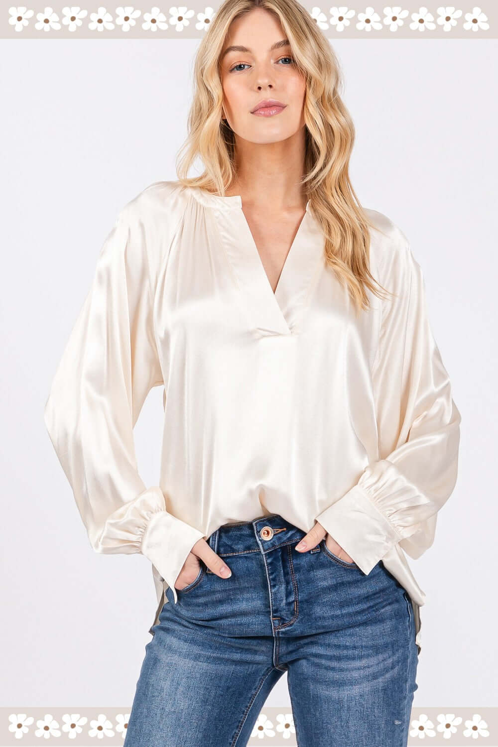 Woman wearing a notched long sleeve blouse in viscose with raglan sleeves and split neckline, paired with jeans, perfect for versatile styling.