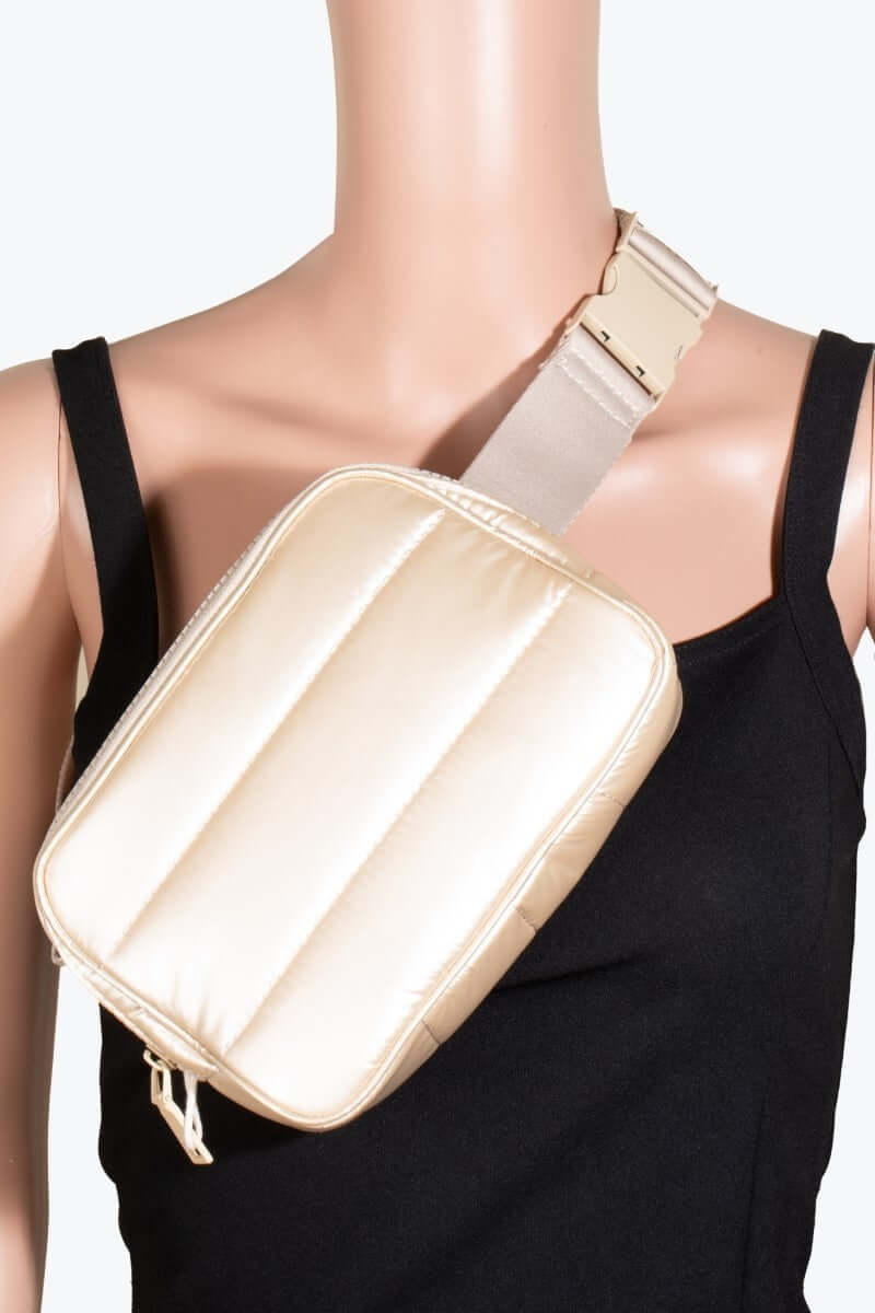 Stylish quilted nylon crossbody bag in cream worn on model, showcasing its practical design for everyday use.