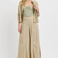 Stylish woman in beige outfit featuring a flowy top and wide-leg pants, perfect for casual or formal occasions.