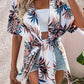 Elegant woman in Bella Road Swim cover up with Birds of Paradise pattern, perfect for beach style and summer vibes.