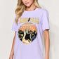 Woman wearing a lavender graphic round neck short sleeve T-shirt with "Nashville, Tennessee" design.