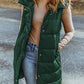 Woman wearing Bella Road Longline Hooded Sleeveless Puffer Vest in green, perfect for layering and outdoor adventures.