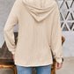 Woman wearing beige drawstring dropped shoulder long sleeve hoodie with back view.