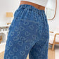 Model showcases Bella Road Denim Heart Washed Straight Leg Jeans with playful heart pattern and elastic waistband.