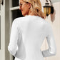 Woman wearing Bella Road Button Up Long Sleeve Cardigan in white, standing outside with back view showing ribbed texture.