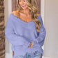 Woman wearing Bella Road frayed hem dropped shoulder sweater in lavender, styled with casual jeans.