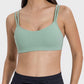 Stylish woman in a mint green double strap active cami, perfect for workouts and casual outings.