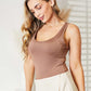 Woman wearing Everyday Full Size Basic Tank Bodysuit in brown, styled with a light skirt, showcasing a sleek and comfortable fit.