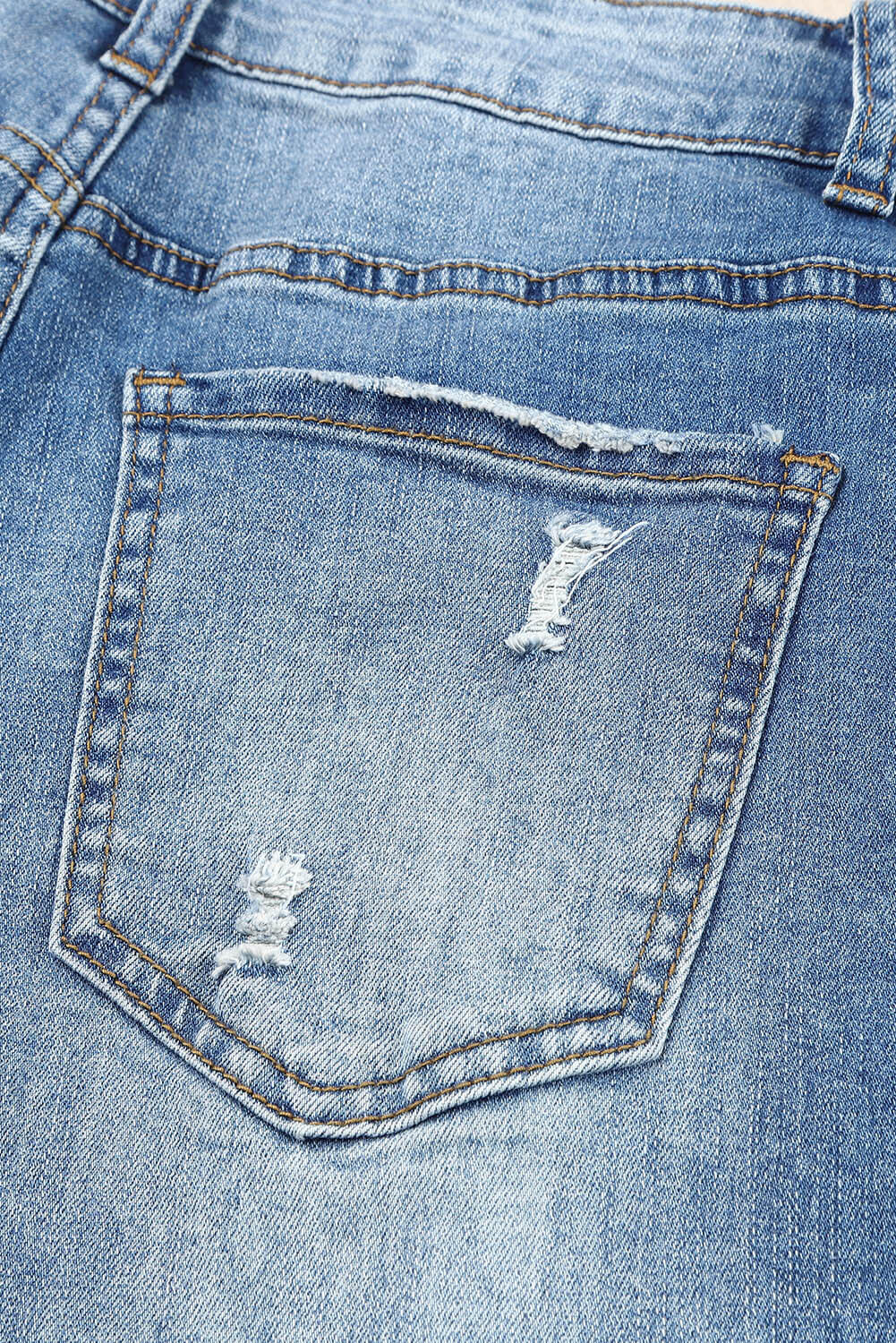 Close-up of back pocket on Baeful Checkered Patchwork Mid Waist Distressed Jeans.