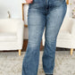 Woman wearing High Waist Tummy Control Flare Jeans by Judy Blue, perfect for a trendy and flattering outfit, showcasing stylish flare legs.